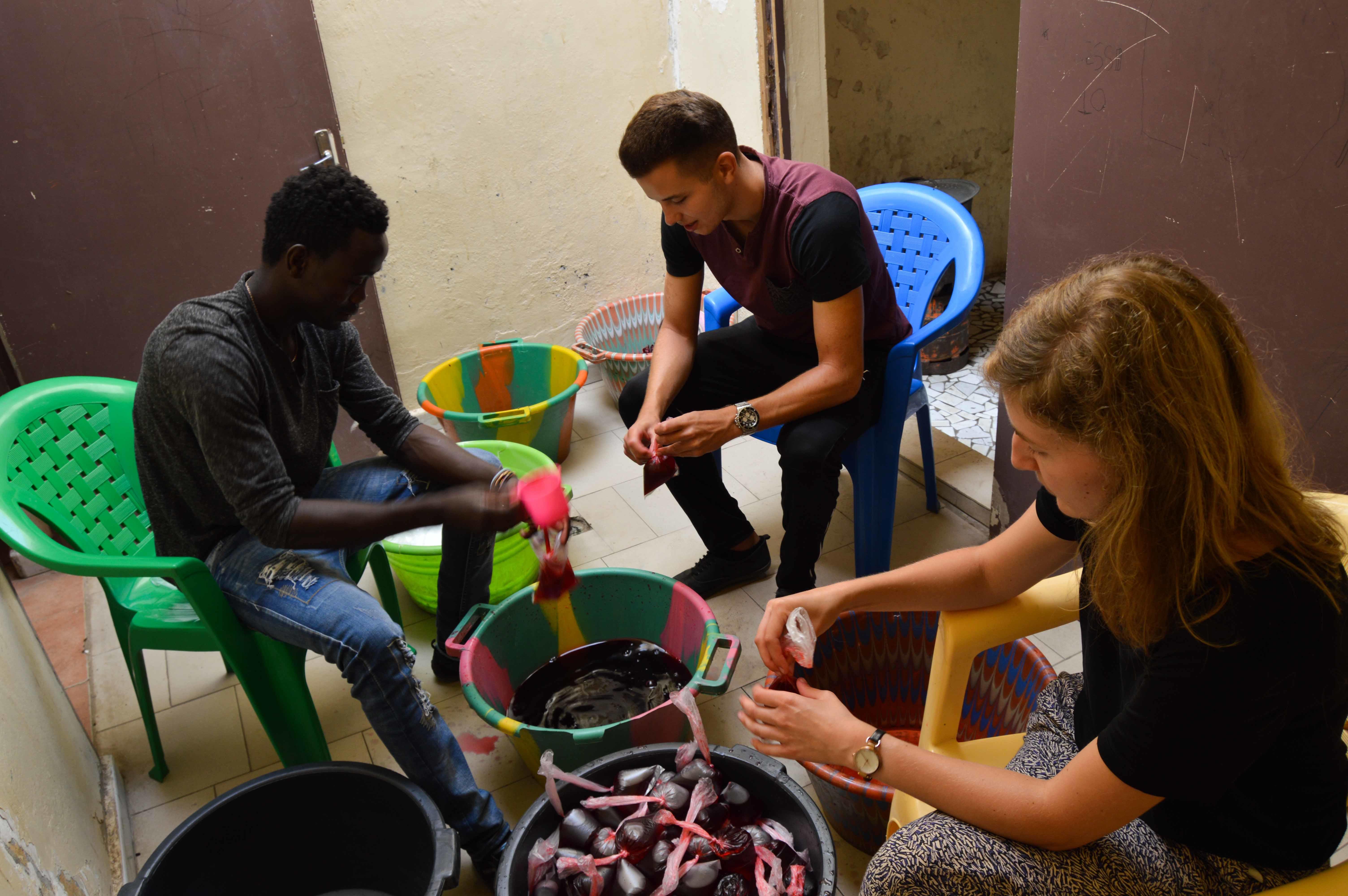 A Projects Abroad group prepares juices for talibés for their volunteer work with children in Senegal. A group prepares juices for talibés while they volunteer with children in Senegal.